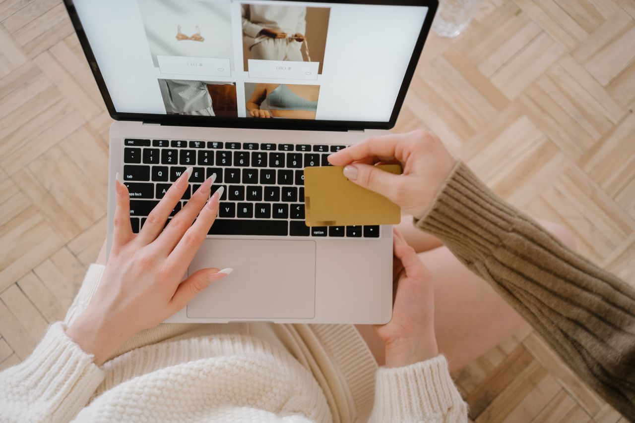 why-choose-us Person shopping online using a laptop and credit card, highlighting e-commerce convenience.